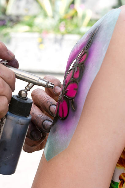 airbrushing tattoo with a stencil